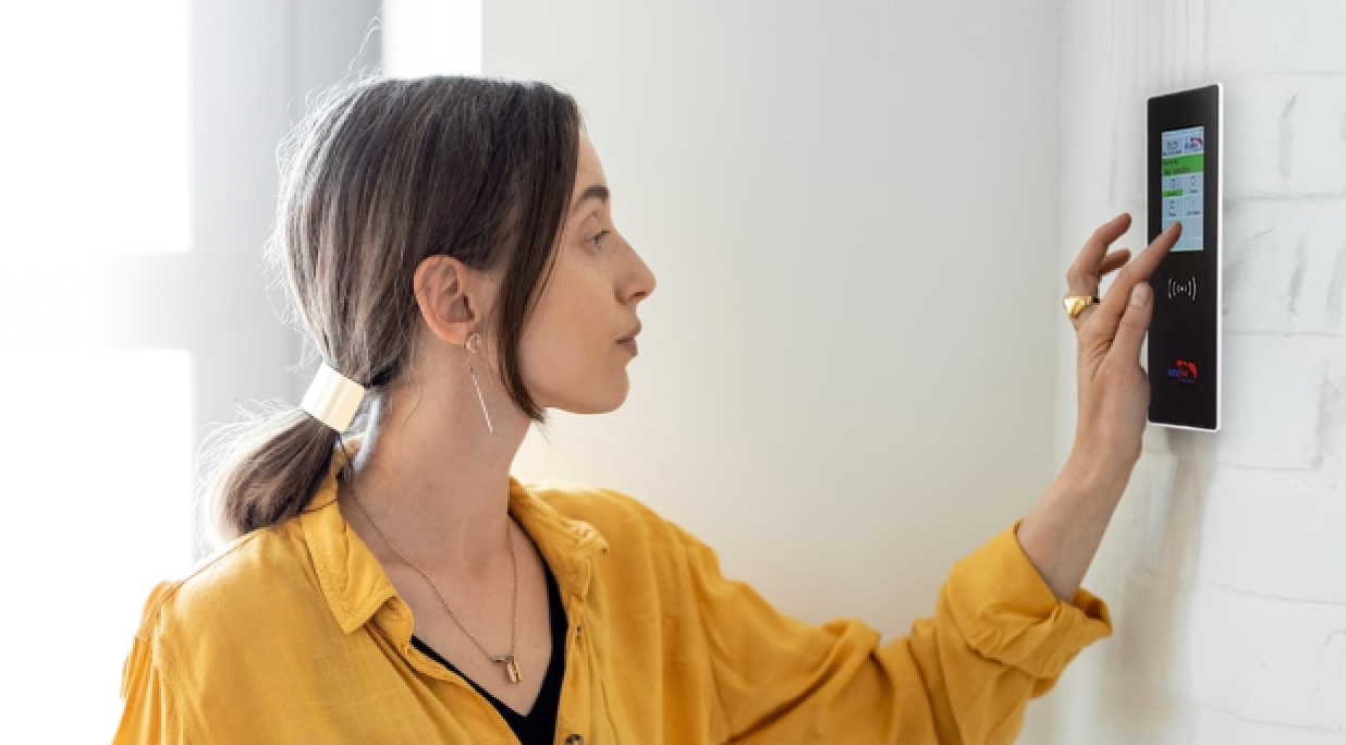 A female employee clocking in using a physical time tracking terminal